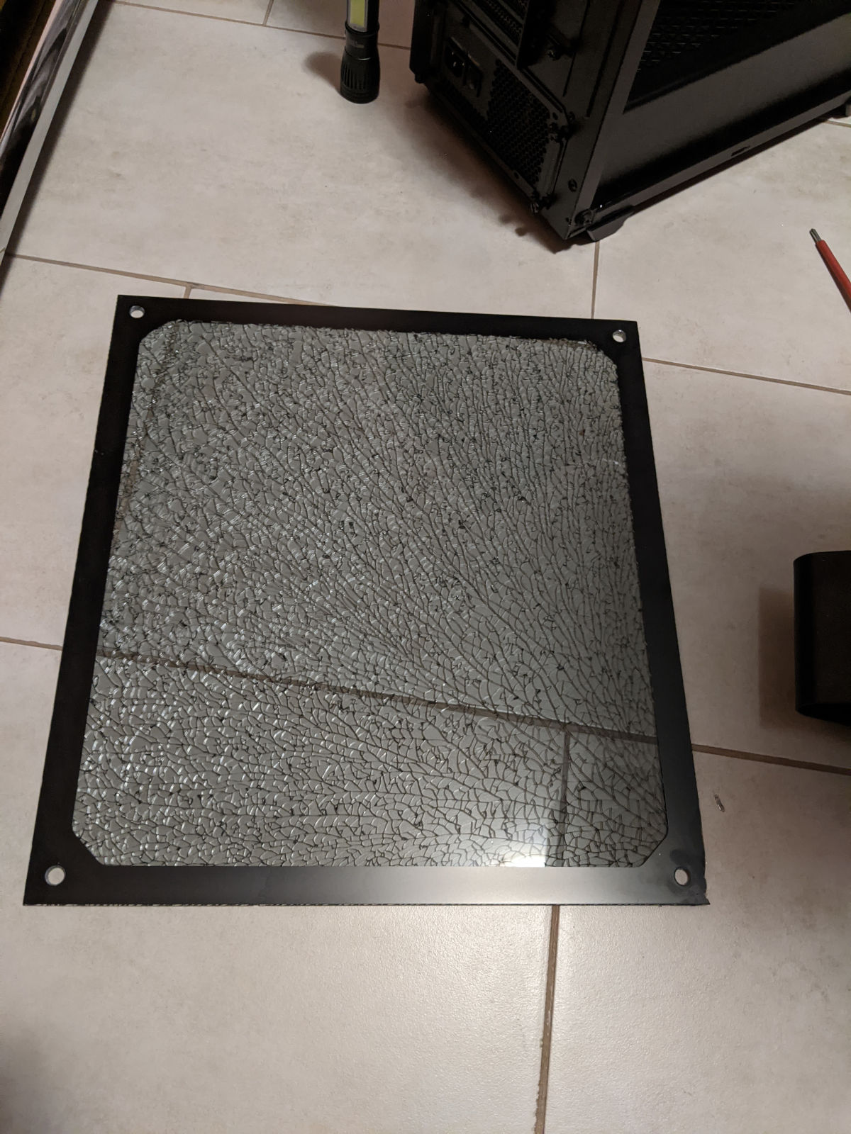 Shattered glass side panel of a desktop case